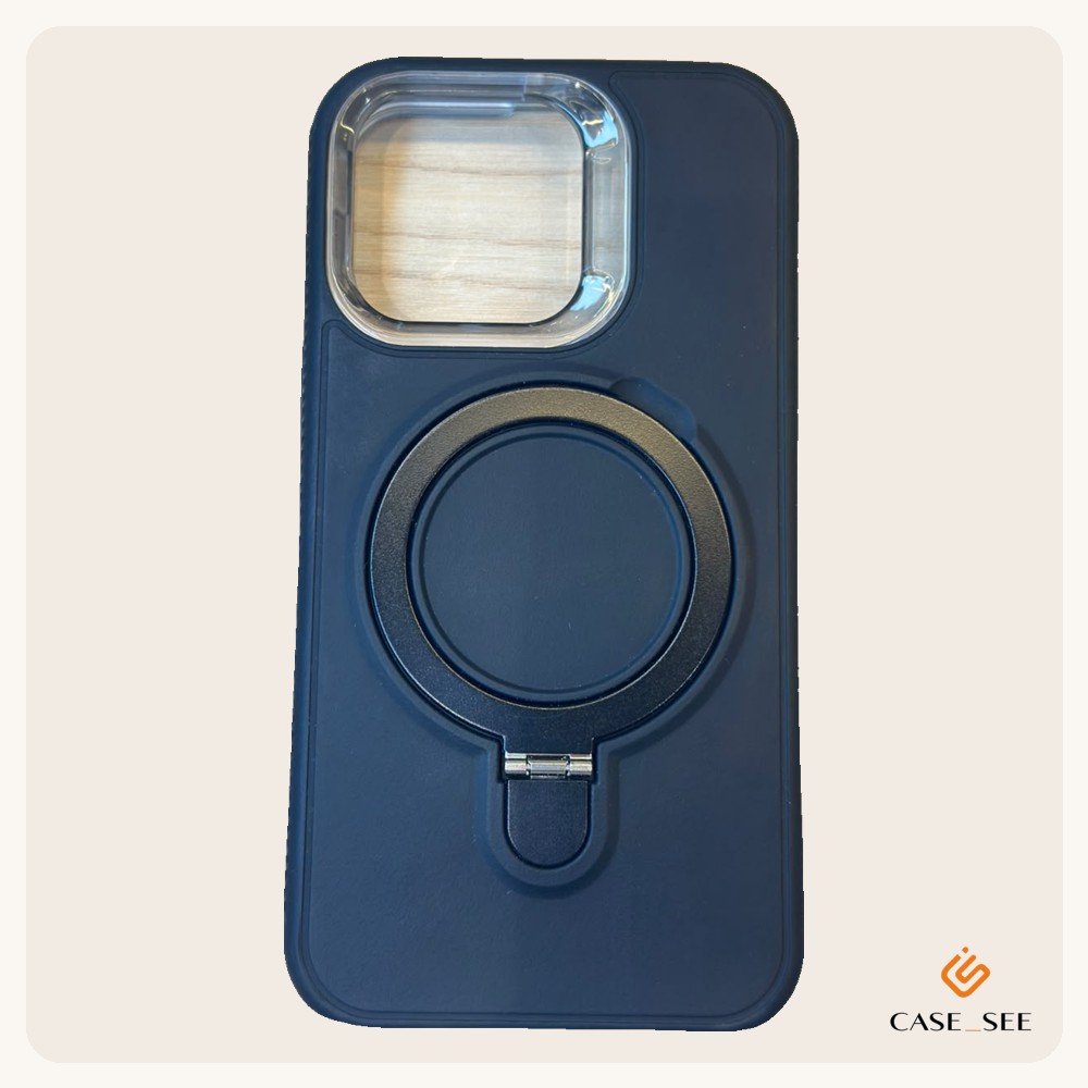 Capa azul marinho fosca com anel redondo no meio que abre e vira suporte, e moldura transparente em volta da câmera.